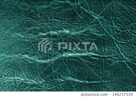 Detailed turquoise colored wrinkled textured leather with natural creases texture background Detailed turquoise colored wrinkled textured leather with natural creases texture background 140237539