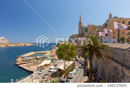 Seafront view of Senglea Malta with church spire and waterfront road Seafront view of Senglea Malta with church spire and waterfront road 140237695