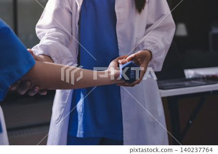 Physical therapist giving stretching exercises with elastic exercise bands and physical therapist hands helping male patient Physical therapy concept Physical therapist giving stretching exercises with elastic exercise bands and physical therapist hands helping male patient Physical therapy concept 140237764