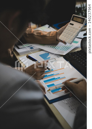 Business accounting concept, Business man using calculator with computer laptop, budget and loan paper in office. Business accounting concept, Business man using calculator with computer laptop, budget and loan paper in office. 140237964