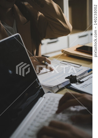 Business accounting concept, Business man using calculator with computer laptop, budget and loan paper in office. 140238002