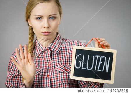 Woman holding board with gluten sign Woman holding board with gluten sign 140238228