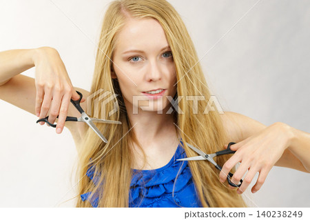 Girl with scissors for haircutting Girl with scissors for haircutting 140238249