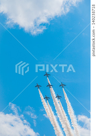 Blue Impulse aerobatic team flying in formation against a clear blue sky at Kamifurano Garrison. 140238718