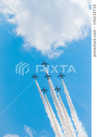 Blue Impulse aerobatic team flying in formation against a clear blue sky at Kamifurano Garrison. 140238719
