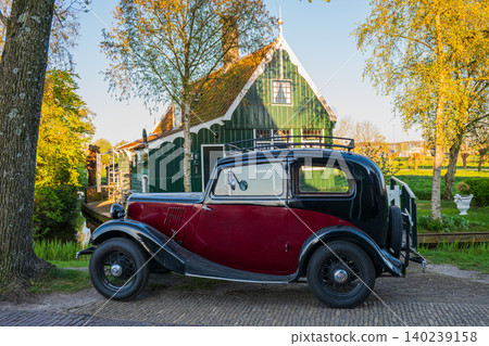 Vintage oldtimer car parVintage oldtimer car parked in front of traditional green Dutch house during golden hourked in front of traditional green Dutch house during golden hour Vintage oldtimer car parVintage oldtimer car parked in front of traditional green Dutch house during golden hourked in front of traditional green Dutch house during golden hour 140239158