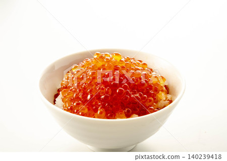 A bowl of vibrant salmon roe served in a white bowl, a luxurious seafood feast. A bowl of vibrant salmon roe served in a white bowl, a luxurious seafood feast. 140239418