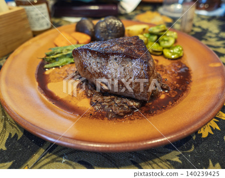 A blissful dinner, the allure of a thick steak. 140239425