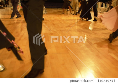 Motion blur of the feet of dancers dancing on the dance floor of a dance hall. Motion blur of the feet of dancers dancing on the dance floor of a dance hall. 140239751