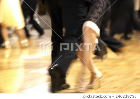Motion blur of the feet of dancers dancing on the dance floor of a dance hall. Motion blur of the feet of dancers dancing on the dance floor of a dance hall. 140239753
