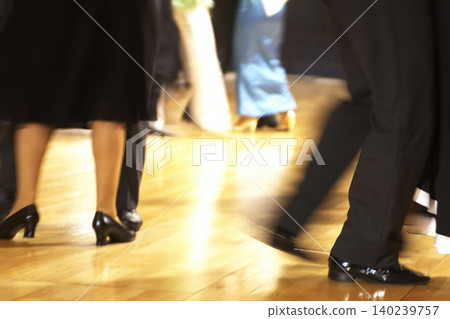 Motion blur of the feet of dancers dancing on the dance floor of a dance hall. Motion blur of the feet of dancers dancing on the dance floor of a dance hall. 140239757