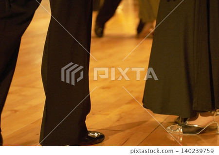 Motion blur of the feet of dancers dancing on the dance floor of a dance hall. Motion blur of the feet of dancers dancing on the dance floor of a dance hall. 140239759