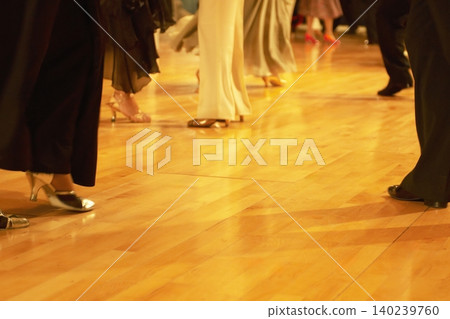 Motion blur of the feet of dancers dancing on the dance floor of a dance hall. Motion blur of the feet of dancers dancing on the dance floor of a dance hall. 140239760