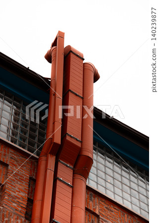 Industrial Ventilation Ducts and Orange Utility Pipes on Brick Wall Industrial Ventilation Ducts and Orange Utility Pipes on Brick Wall 140239877