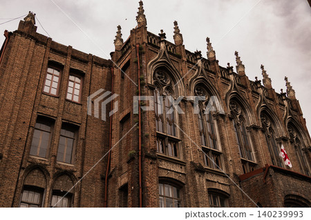Historic Gothic Revival Brick Building with Pointed Arches and Ornate Facade 140239993