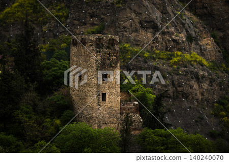 Ancient Stone Watchtower Surrounded by Forest and Rocky Cliff Ancient Stone Watchtower Surrounded by Forest and Rocky Cliff 140240070