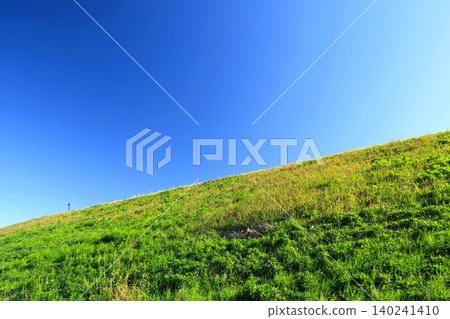 Landscape of the Edogawa river bank in winter with young grass growing Landscape of the Edogawa river bank in winter with young grass growing 140241410