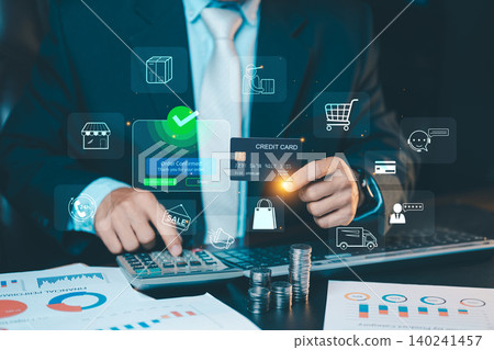 Businessman holding a credit card with confirmed online shopping order and retail icons on virtual interface. E-commerce concept. 140241457