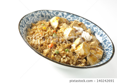 Mapo tofu-topped fried rice photographed against a white background. Mapo tofu-topped fried rice photographed against a white background. 140242691