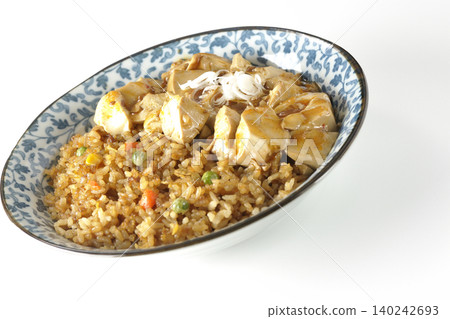 Mapo tofu-topped fried rice photographed against a white background. Mapo tofu-topped fried rice photographed against a white background. 140242693