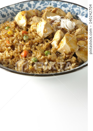 Mapo tofu-topped fried rice photographed against a white background. Mapo tofu-topped fried rice photographed against a white background. 140242704
