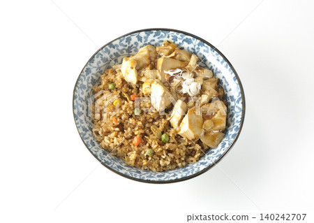 Mapo tofu-topped fried rice photographed against a white background. Mapo tofu-topped fried rice photographed against a white background. 140242707