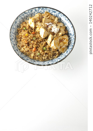 Mapo tofu-topped fried rice photographed against a white background. Mapo tofu-topped fried rice photographed against a white background. 140242712