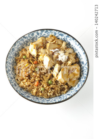 Mapo tofu-topped fried rice photographed against a white background. Mapo tofu-topped fried rice photographed against a white background. 140242713