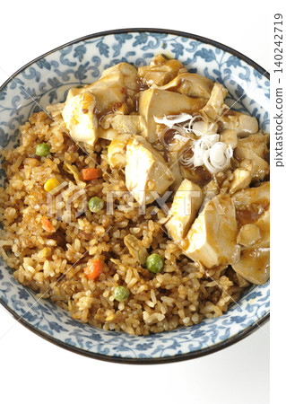 Mapo tofu-topped fried rice photographed against a white background. Mapo tofu-topped fried rice photographed against a white background. 140242719