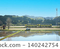 A local train line running through a rural landscape. 140242754