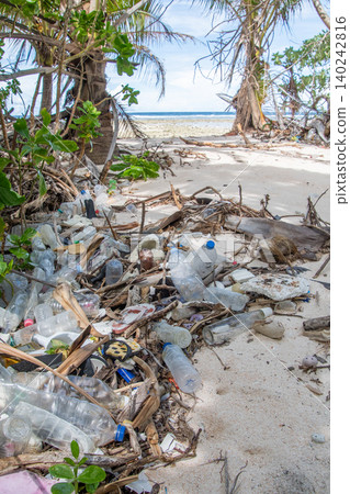 Environmental problem: Plastic waste washes ashore on a beach on a southern island. Environmental problem: Plastic waste washes ashore on a beach on a southern island. 140242816