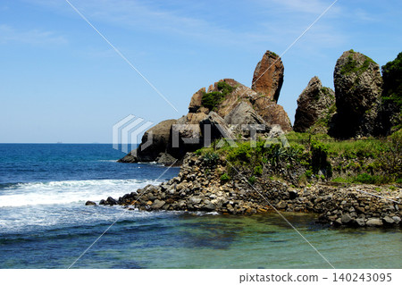 A view of the Minato no Tatekami Rock, a popular tourist spot in Karatsu City, Saga Prefecture, and the Genkai Sea, a popular surfing spot. A view of the Minato no Tatekami Rock, a popular tourist spot in Karatsu City, Saga Prefecture, and the Genkai Sea, a popular surfing spot. 140243095