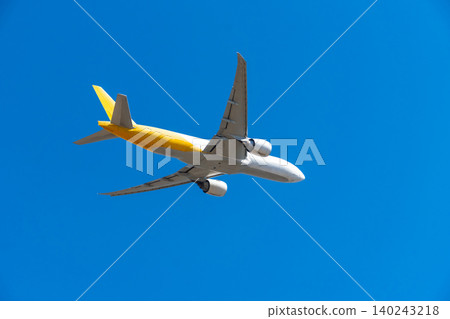 Image of a cargo plane flying through a blue sky Image of a cargo plane flying through a blue sky 140243218