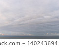 A minimalist seascape with a faint pink light spreading across the horizon. 140243694