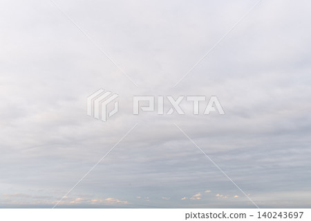 天空陰雲密布,地平線上泛著淡淡的粉紅色光芒,景色寧靜祥和。 天空陰雲密布,地平線上泛著淡淡的粉紅色光芒,景色寧靜祥和。 140243697
