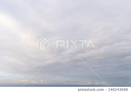 A fantastical seascape woven from the lingering glow of pale pink and gentle layers of clouds. A fantastical seascape woven from the lingering glow of pale pink and gentle layers of clouds. 140243698
