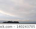 A delicate pastel cloudscape and the silhouette of Enoshima floating on a calm sea. 140243705