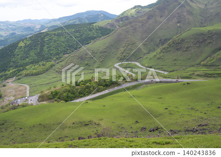 The sharp curves of the Yamanami Highway as seen from the Yufu Silky Road - Oita Prefecture The sharp curves of the Yamanami Highway as seen from the Yufu Silky Road - Oita Prefecture 140243836