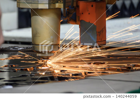 Industrial fiber laser cutting machine operation processing and cutting through a metal plate. 140244059