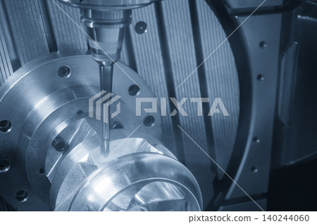 High-precision 5-axis CNC milling machine cutting a complex shape part with a ball nose end mill tool in a blue tone scene. High-precision 5-axis CNC milling machine cutting a complex shape part with a ball nose end mill tool in a blue tone scene. 140244060