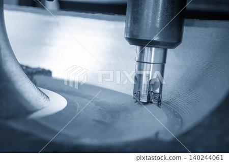 Close-up of a heavy duty rough cutting process on cast iron parts using an indexable tool on a CNC milling machine. Close-up of a heavy duty rough cutting process on cast iron parts using an indexable tool on a CNC milling machine. 140244061