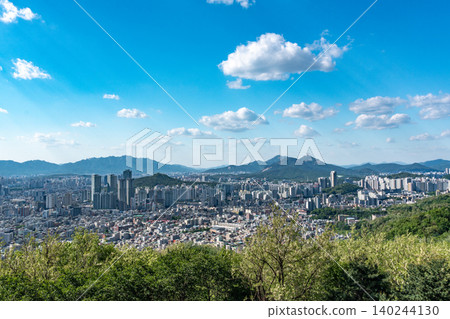 Panoramic view of downtown Seoul city skyline from Yongmasan mountain observatory on a clear spring afternoon Panoramic view of downtown Seoul city skyline from Yongmasan mountain observatory on a clear spring afternoon 140244130