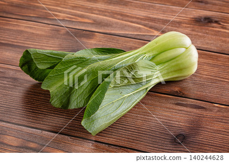 Fresh green bok choy on rustic wooden table background Fresh green bok choy on rustic wooden table background 140244628
