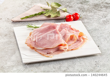 Sliced ham on white plate with fresh herbs and cherry tomatoes Sliced ham on white plate with fresh herbs and cherry tomatoes 140244645
