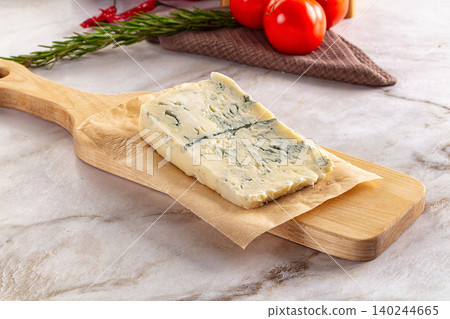 Blue Cheese Wedge on Wooden Board with Tomatoes and Rosemary Blue Cheese Wedge on Wooden Board with Tomatoes and Rosemary 140244665