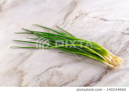 Fresh green onions on marble surface Fresh green onions on marble surface 140244668
