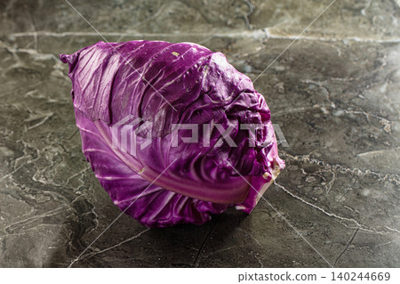 Fresh purple cabbage on dark marble background Fresh purple cabbage on dark marble background 140244669
