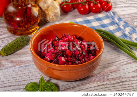 beet salad in terracotta bowl with fresh vegetables beet salad in terracotta bowl with fresh vegetables 140244797
