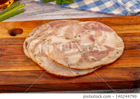 Sliced ham on wooden board with fresh herbs Sliced ham on wooden board with fresh herbs 140244799