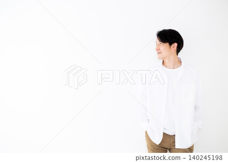 Portrait of a young middle-aged man wearing a white shirt, against a white background. 140245198